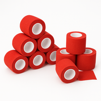A group of red TapeGeeks cohesive bandage rolls arranged on a white background, showing the flexible, secure compression wrap for injury prevention and joint stability.