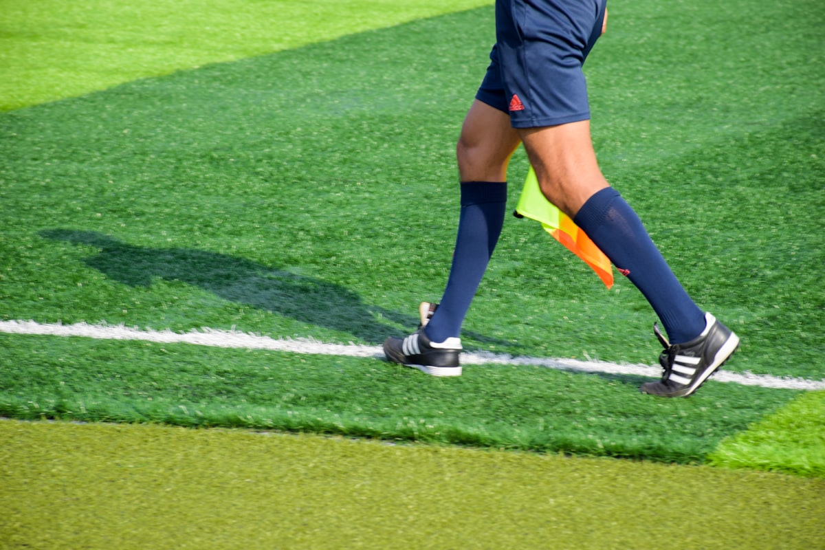 Kinesiology tape applied to ankle for lateral ankle sprain support and prevention