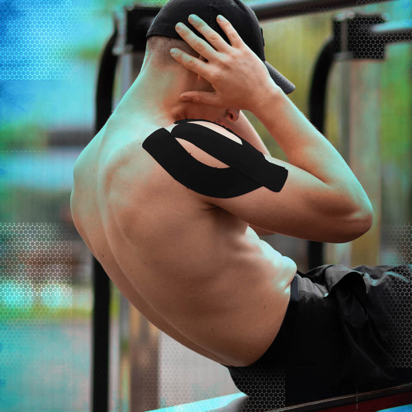 Man applying black TapeGeeks kinesiology tape to shoulder for muscle recovery and athletic pain relief during workout.