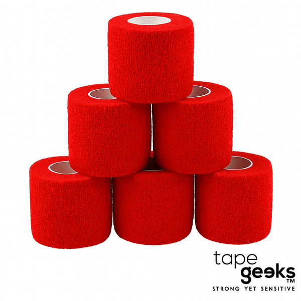Stacked red TapeGeeks 2-inch cohesive bandage rolls showing the self-adhesive, latex-free athletic wrap used for joint support, compression, and injury recovery.