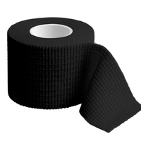 Black roll of TapeGeeks weightlifting tape with a grippy woven texture, partially unrolled to show the stretchable, skin-friendly design used for protecting thumbs, fingers, and joints during CrossFit and strength training.