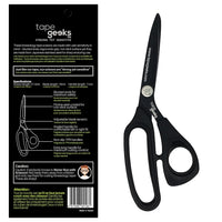 Kinesiology tape scissors by TapeGeeks shown with black carbon and fluorine-resin coated blades and ergonomic non-slip handles, featuring blunted safety tips and angled grip for smooth, precise kinesiology tape cutting.