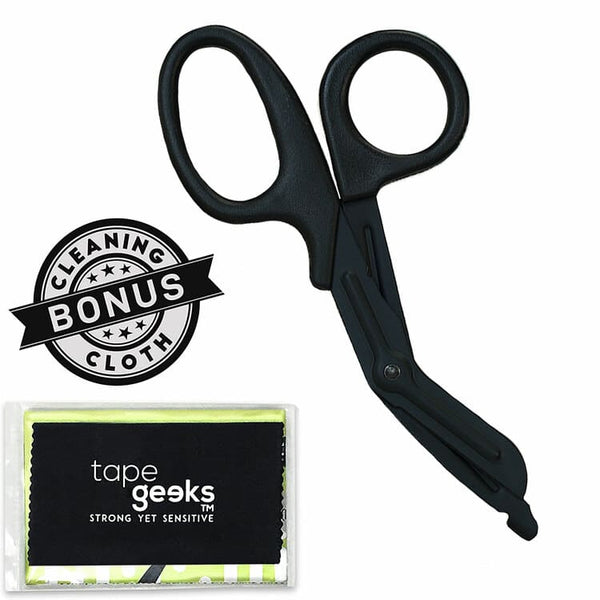 TapeGeeks medical scissors shown with a bonus cleaning cloth, featuring blunted tips and sturdy blades for cutting kinesiology tape, bandages, and fabric with safety and precision.